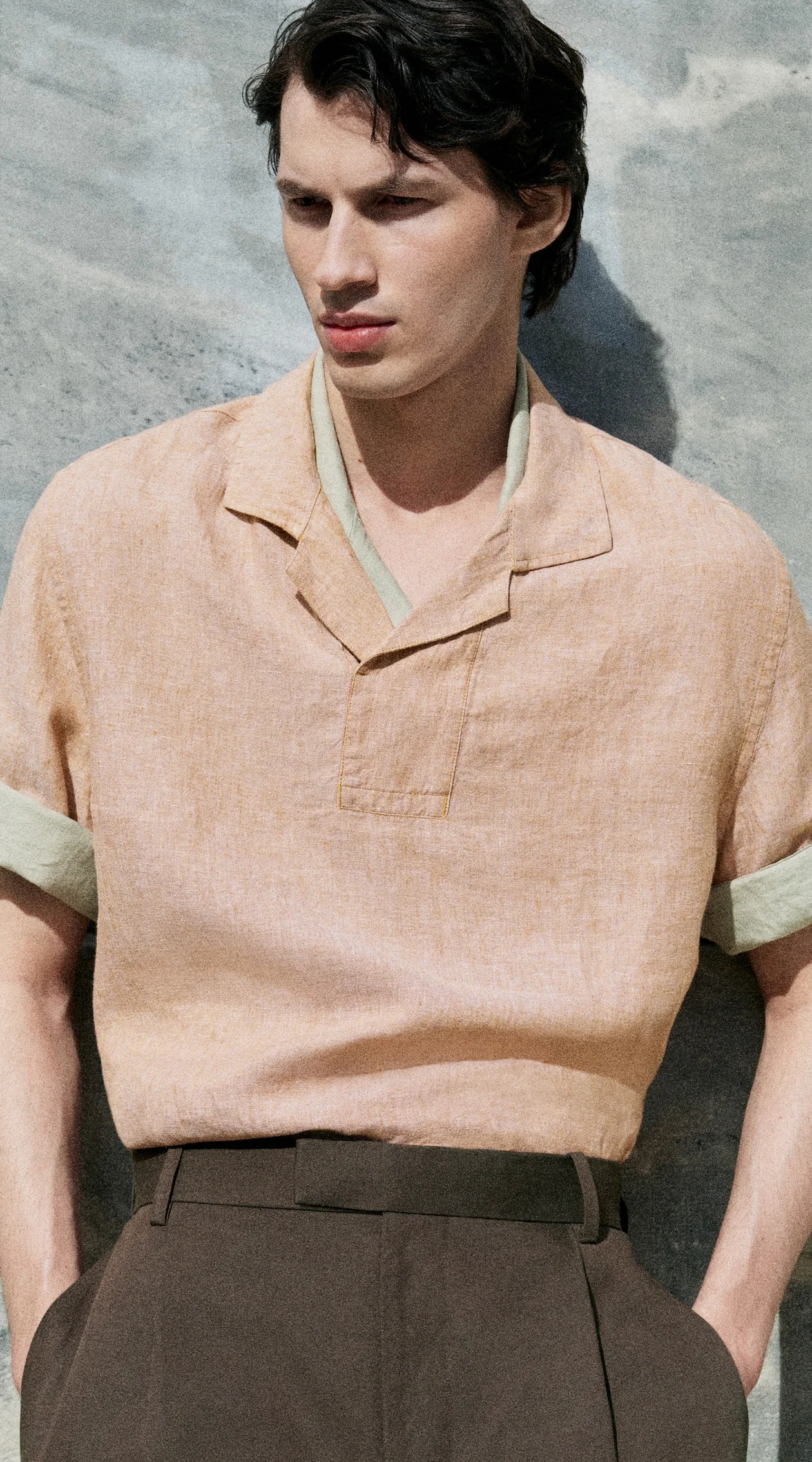 Man wearing a coral linen polo.